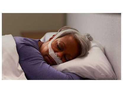 woman sleeping with a Dreamwear mask with silicone headgear